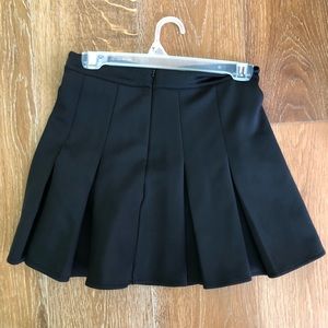 Black pleated woman’s skirt.